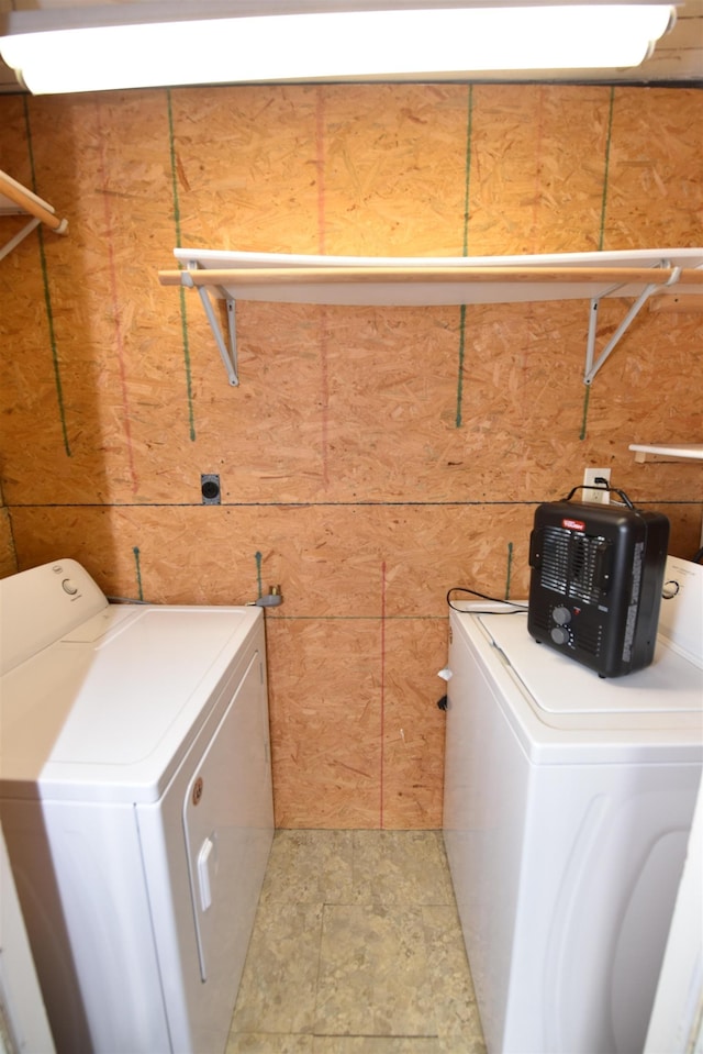 clothes washing area with washer and clothes dryer