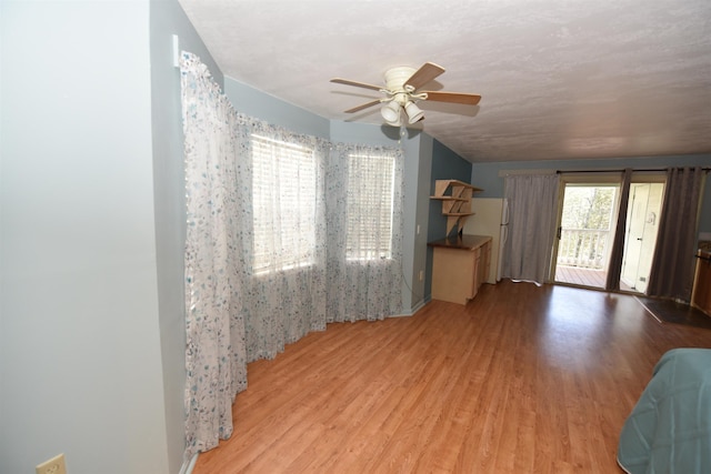 living room with ceiling fan and light wood-type flooring