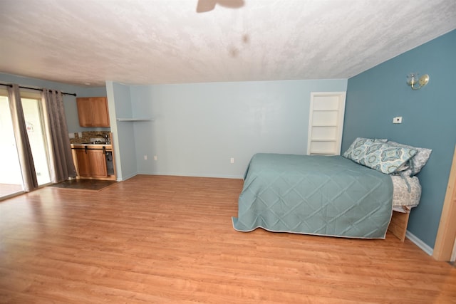 bedroom with connected bathroom and light wood-type flooring