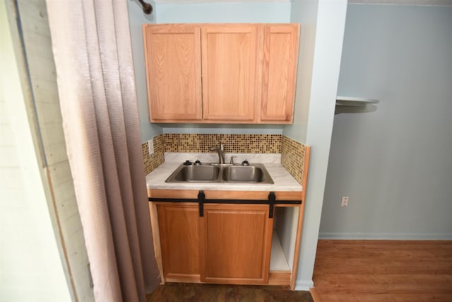 kitchen featuring sink, light brown cabinetry, dark hardwood / wood-style flooring, and decorative backsplash