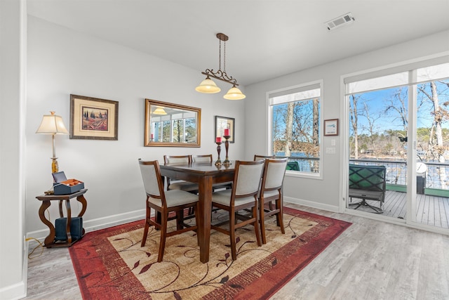 dining space featuring light wood-type flooring