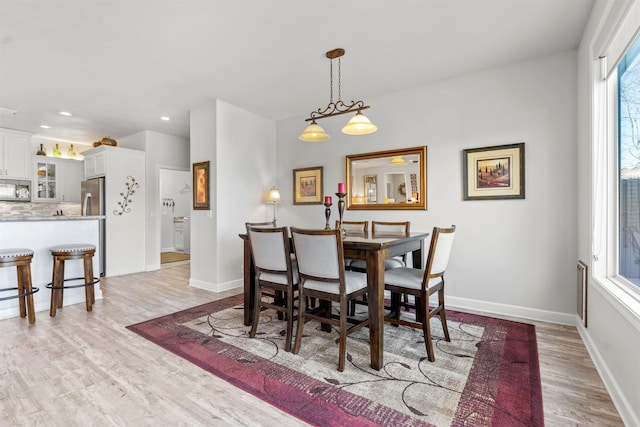 dining area with plenty of natural light and light hardwood / wood-style floors