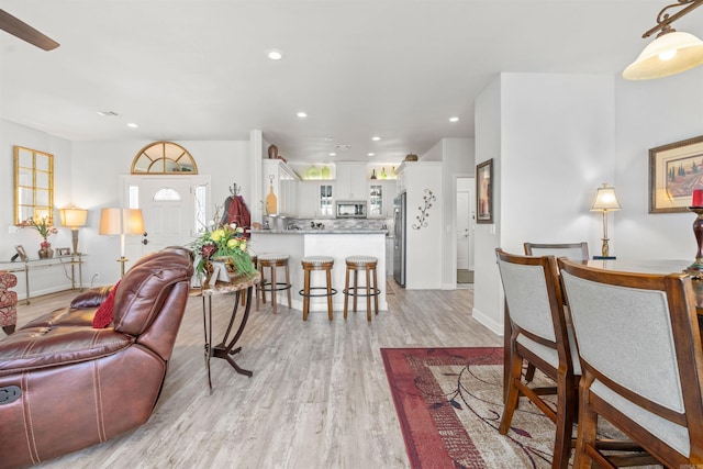 living room with a wealth of natural light and light wood-type flooring