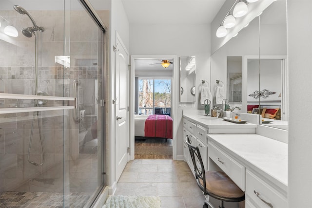 bathroom with vanity, an enclosed shower, and ceiling fan