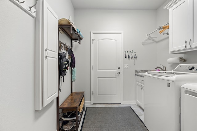 washroom with cabinets and independent washer and dryer