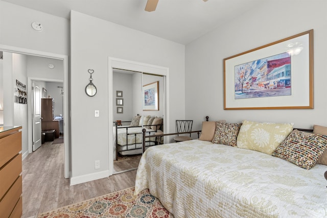 bedroom featuring ceiling fan, a closet, and light hardwood / wood-style flooring