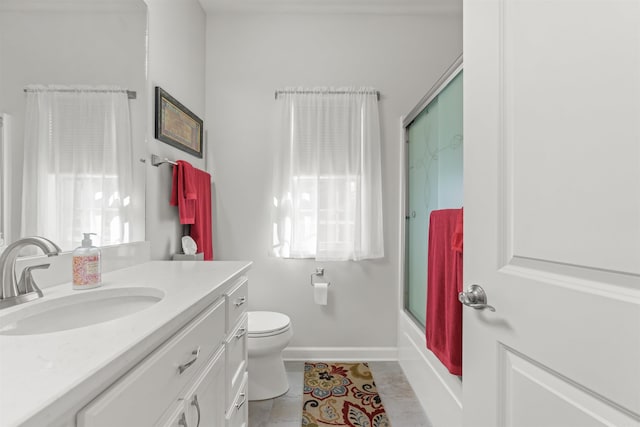 full bathroom with tile patterned flooring, vanity, combined bath / shower with glass door, and toilet