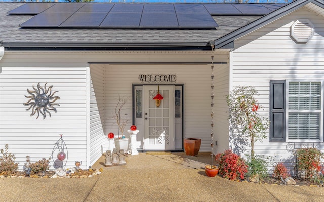 doorway to property featuring solar panels