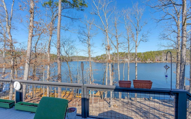 wooden terrace featuring a water view