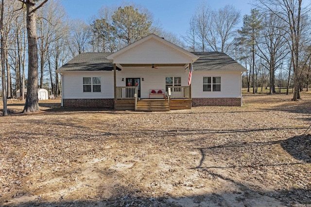 single story home with covered porch and a storage unit