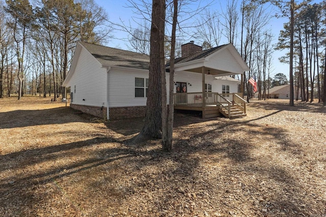 view of side of property featuring a wooden deck