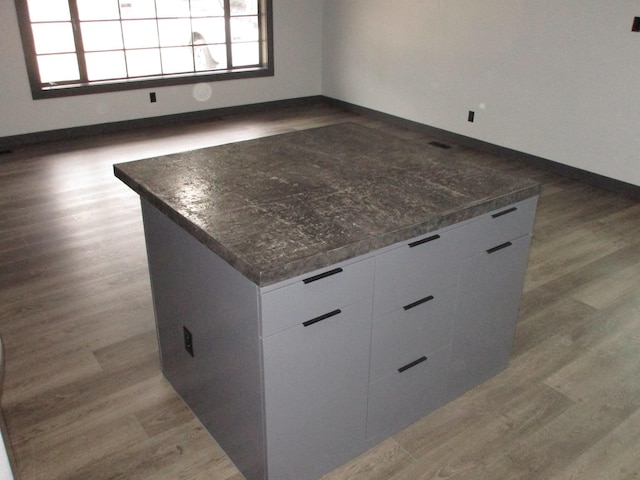 interior space featuring white cabinetry, light hardwood / wood-style flooring, and a kitchen island