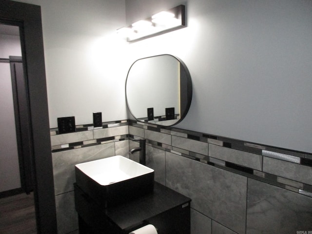 bathroom featuring tile walls and sink