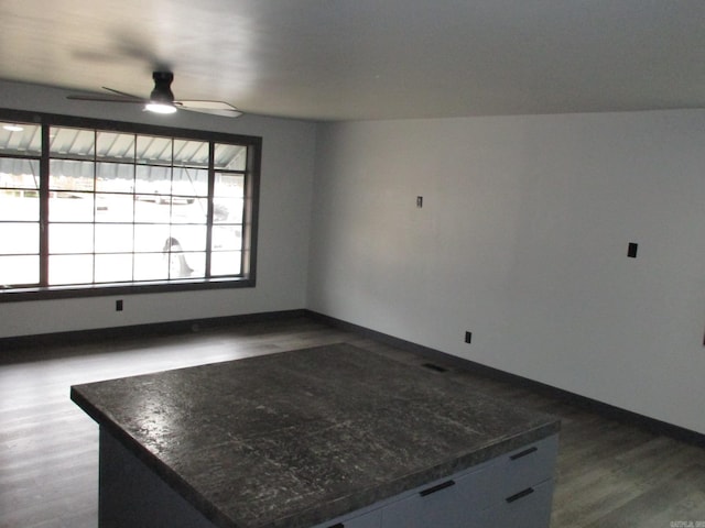 spare room with ceiling fan and dark hardwood / wood-style flooring