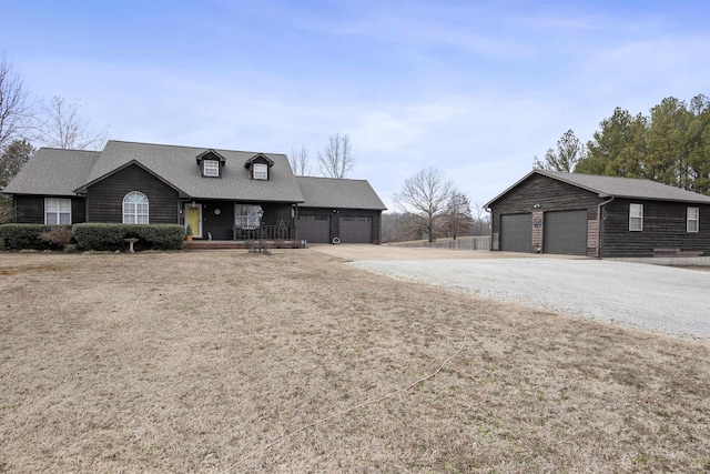 view of front of home featuring a garage, a front lawn, and a porch