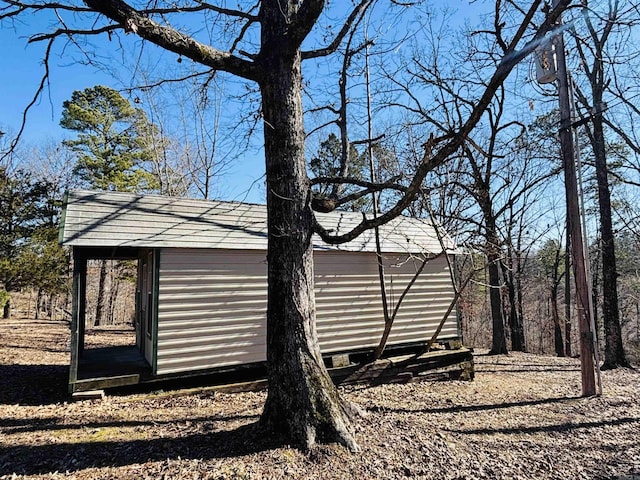 view of side of home featuring an outbuilding