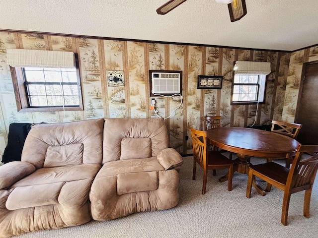 living room with a wall unit AC, a textured ceiling, and carpet flooring