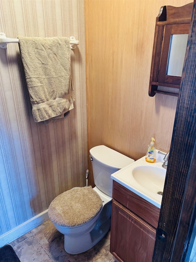 bathroom featuring vanity, tile patterned flooring, and toilet