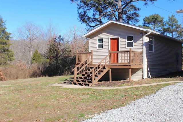 rear view of property featuring a yard