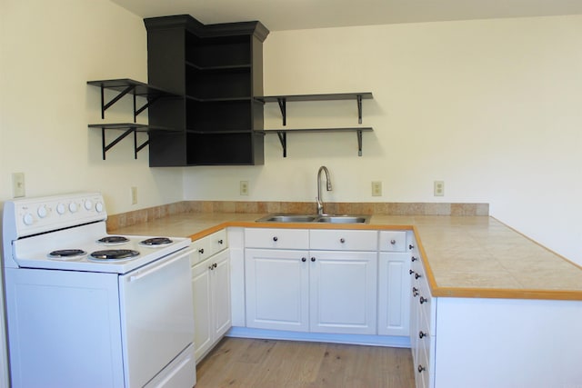 kitchen with white electric range, white cabinetry, sink, tile counters, and light wood-type flooring