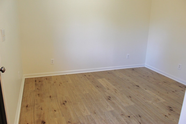 unfurnished room with light hardwood / wood-style flooring