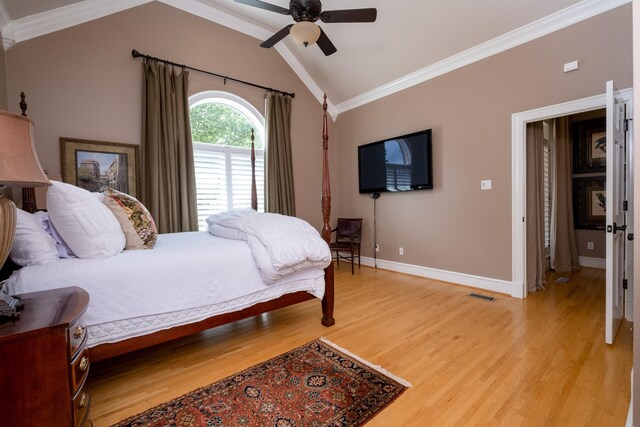 bedroom featuring vaulted ceiling, crown molding, ceiling fan, and light hardwood / wood-style flooring