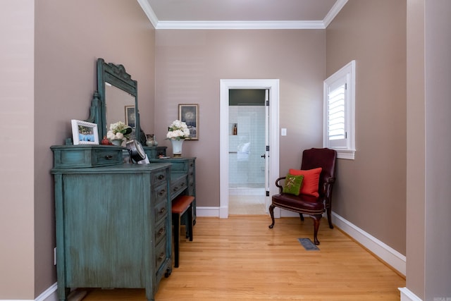 living area featuring ornamental molding and light hardwood / wood-style flooring