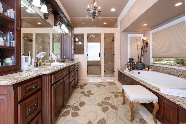 bathroom featuring plus walk in shower, a healthy amount of sunlight, vanity, and a chandelier