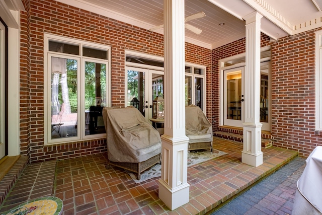 sunroom featuring french doors and ornate columns