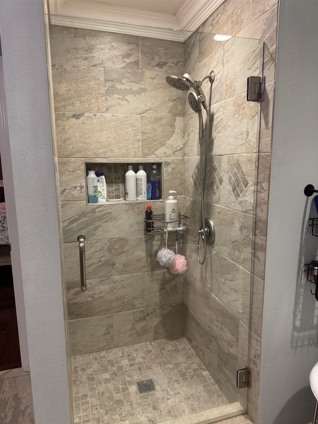 bathroom with crown molding and an enclosed shower