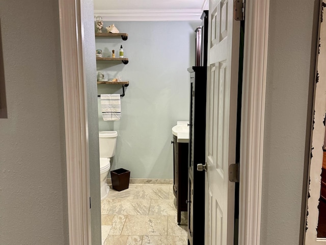 bathroom featuring vanity, crown molding, and toilet