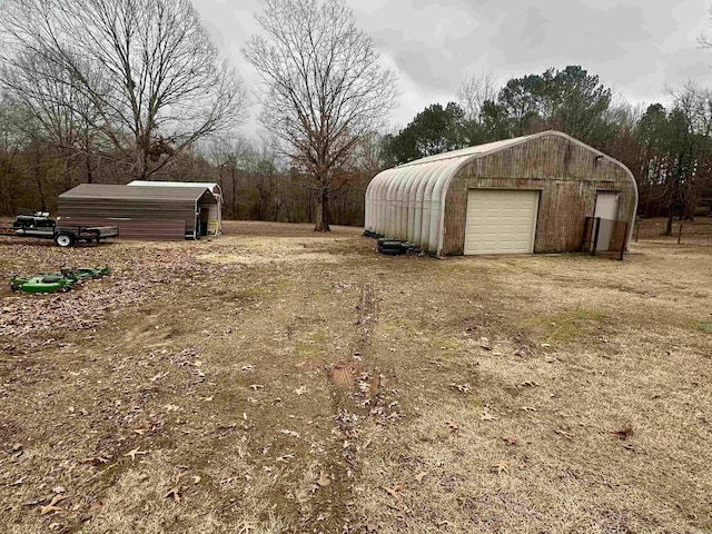 exterior space featuring a garage and an outdoor structure