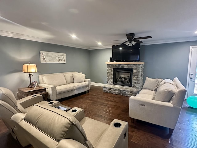 living room with crown molding, a stone fireplace, ceiling fan, and dark hardwood / wood-style flooring