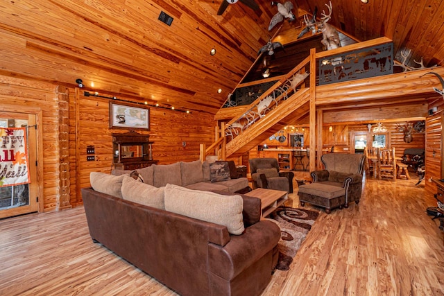 living room featuring wooden ceiling, light wood-type flooring, log walls, and high vaulted ceiling