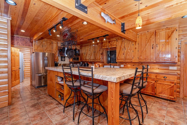 kitchen featuring rail lighting, appliances with stainless steel finishes, beam ceiling, log walls, and wooden ceiling