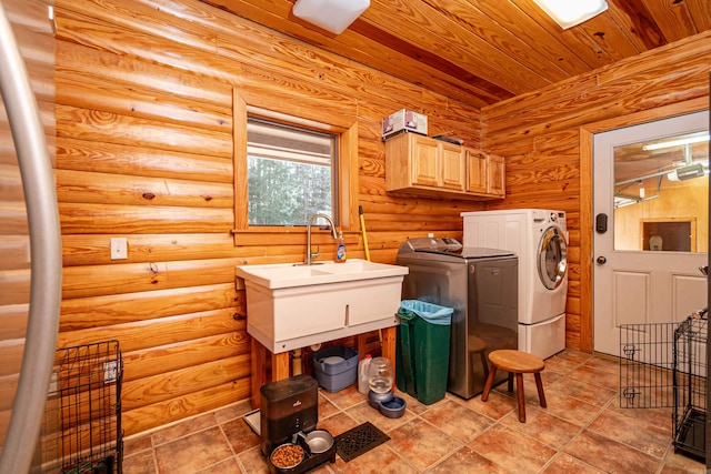 laundry area with cabinets, washing machine and dryer, wooden ceiling, and log walls