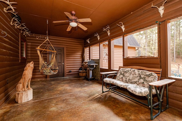 sunroom featuring ceiling fan