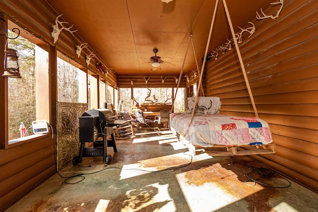 interior space with log walls and concrete flooring