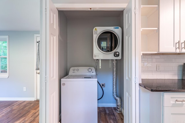 laundry room with washer / clothes dryer and dark wood-type flooring