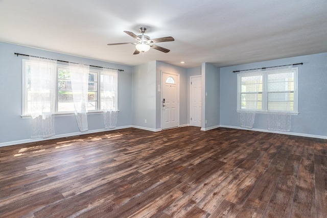 unfurnished room featuring ceiling fan and dark hardwood / wood-style flooring