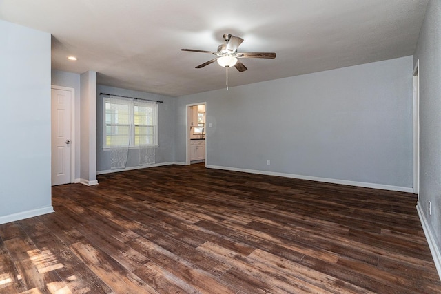 spare room featuring ceiling fan and dark hardwood / wood-style flooring