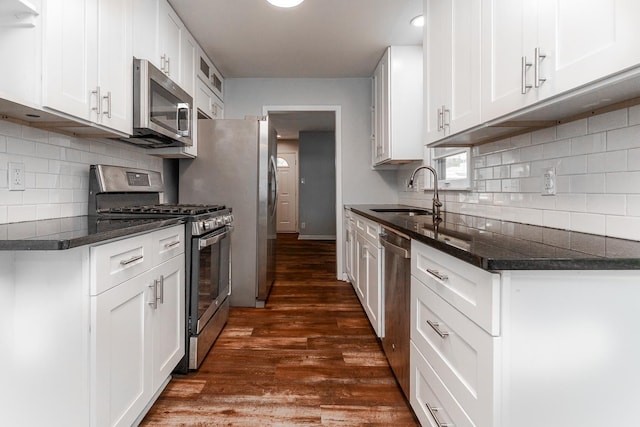 kitchen featuring dark hardwood / wood-style flooring, sink, stainless steel appliances, and white cabinets