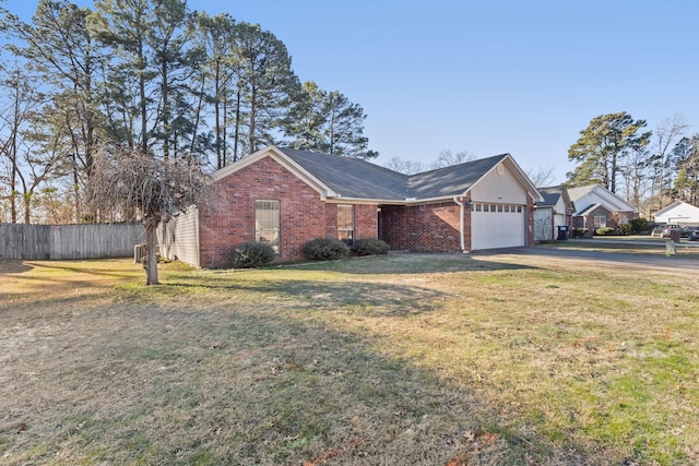 single story home with a garage and a front lawn