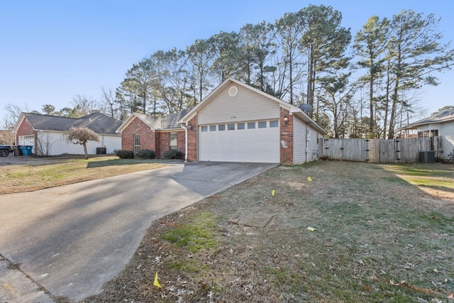 ranch-style house with a garage, central AC, and a front yard