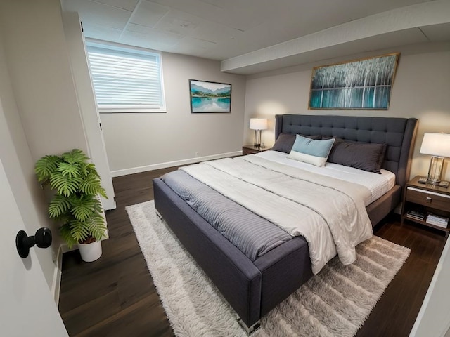 bedroom with dark hardwood / wood-style floors