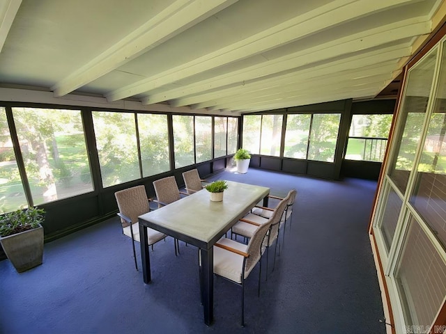 sunroom / solarium with vaulted ceiling with beams