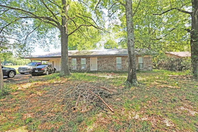 ranch-style house featuring a carport