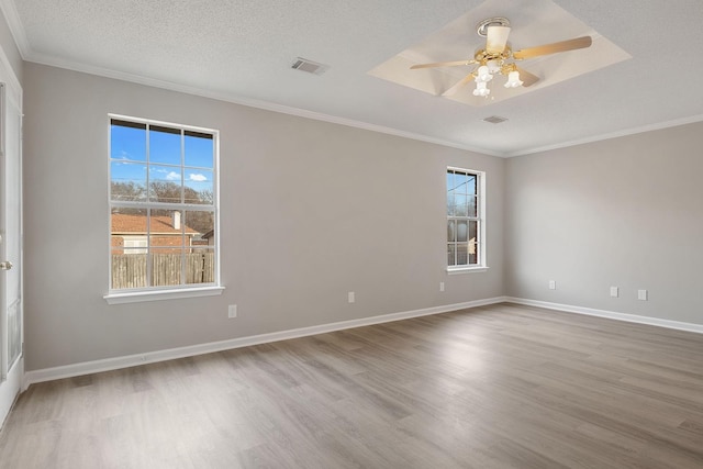 spare room featuring ornamental molding, a textured ceiling, ceiling fan, and light wood-type flooring