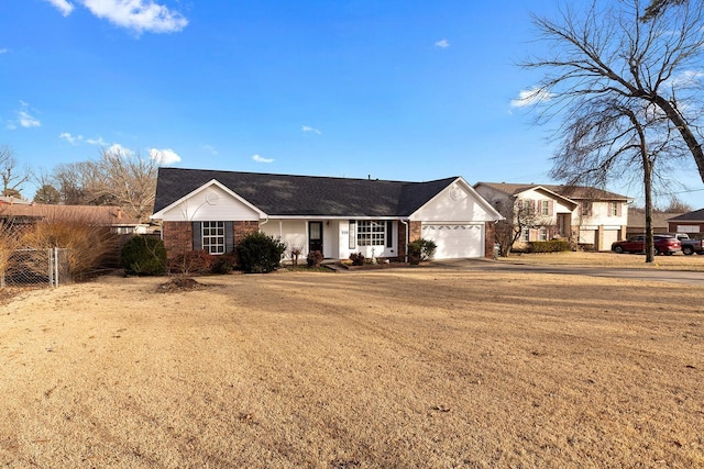 single story home featuring a garage and a front lawn