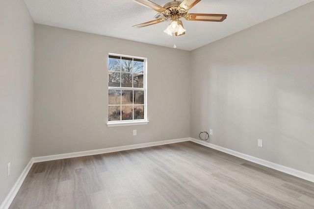 unfurnished room with ceiling fan and light hardwood / wood-style floors